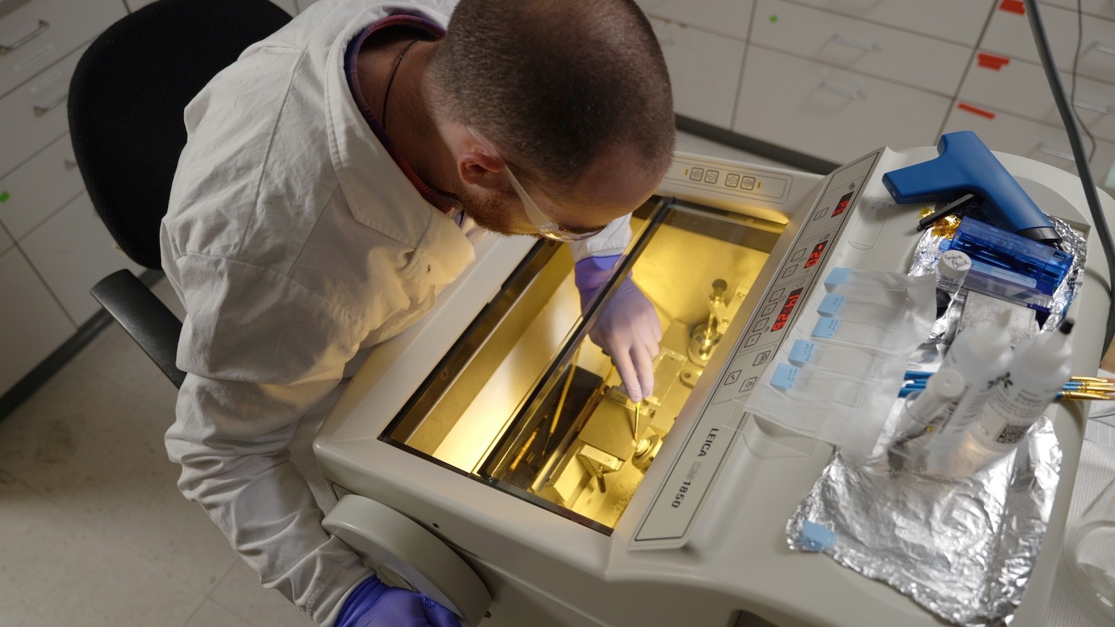 Image shows Bailey McFarland working with a Leica Cryostat.